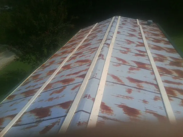 Rusted metal roof panels with new wood purlins before replacement — Storm Damage Roof Repair in Prattsburgh by Roofing Brothers